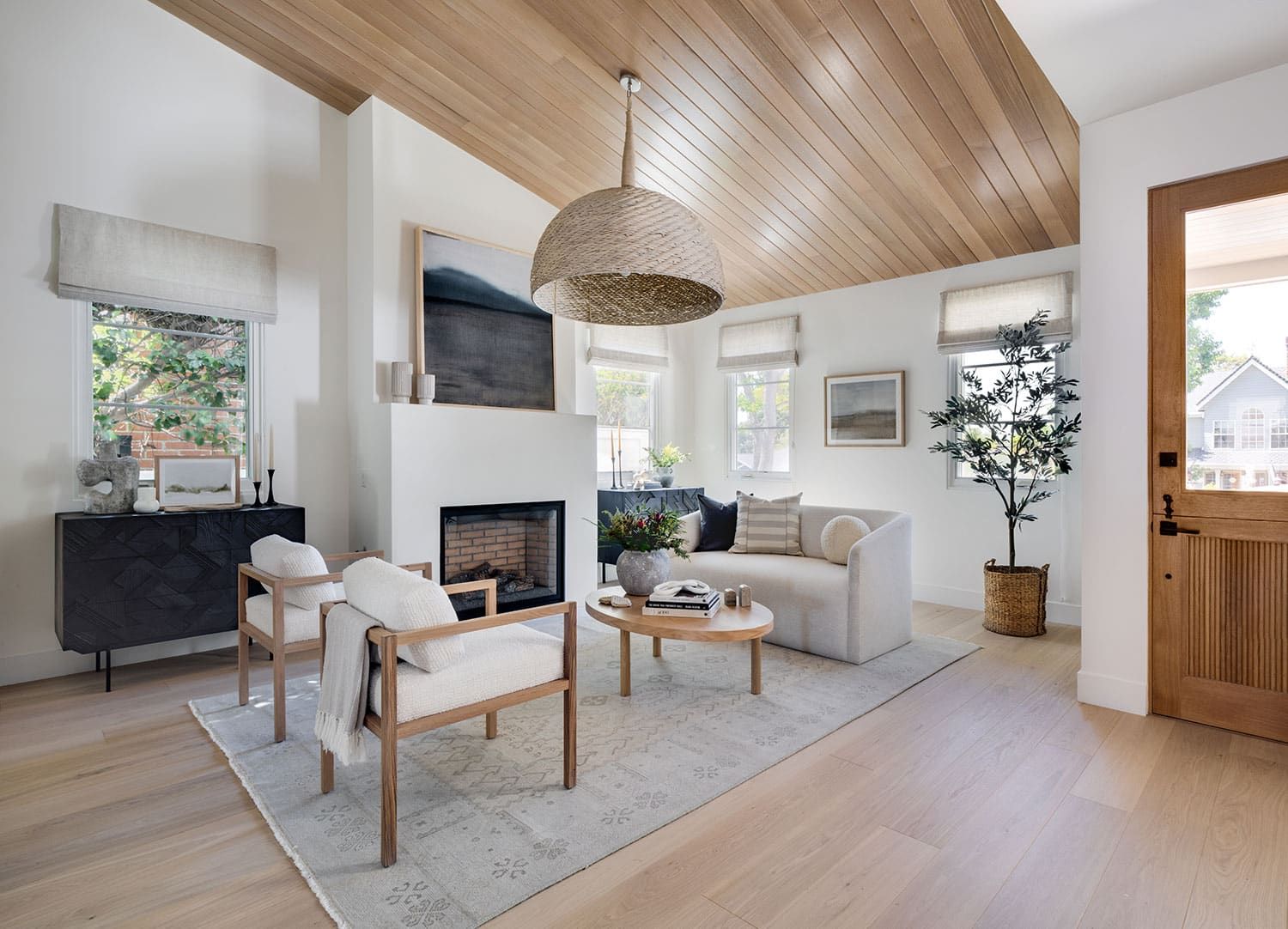 Living room with wood ceiling and fireplace