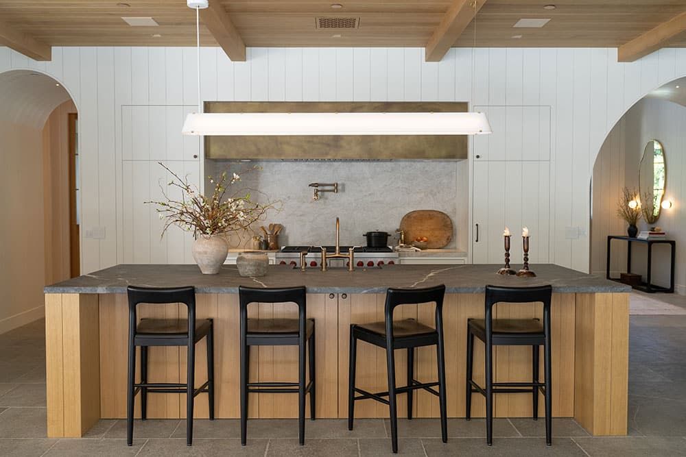 Kitchen with concrete island and beamed ceiling