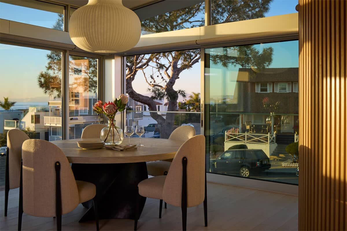 Dining room wrapped in glass with sunset light