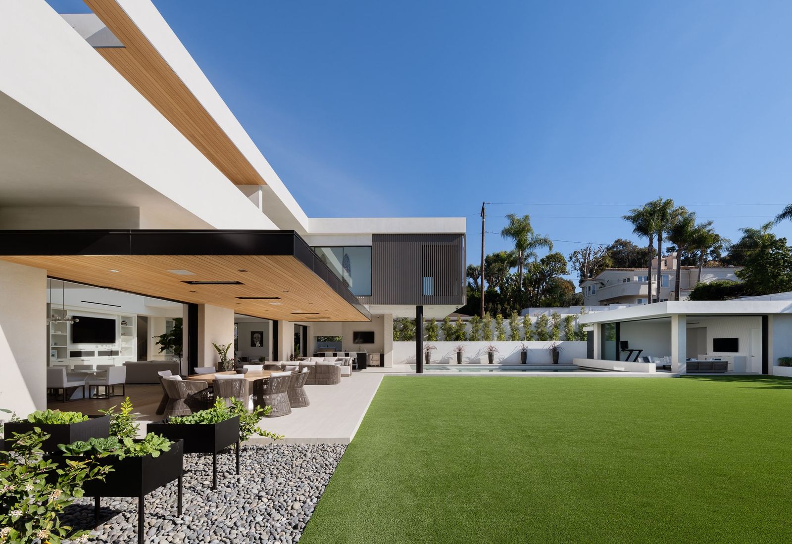 Covered fireplace lounge and lawn at Manhattan Compound